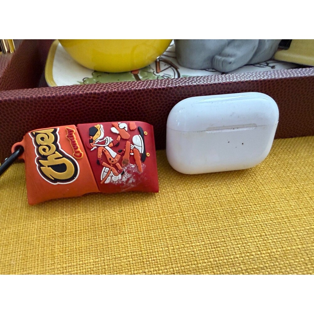 AirPods charger and half of a Cheetos case